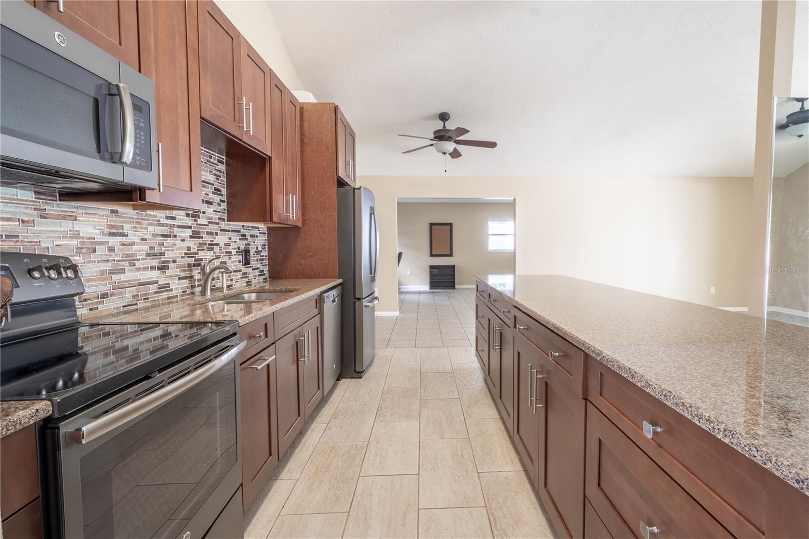 Completely updated kitchen with soft close, wood shaker cabinets, Granite Counters, a suite of Stainless Steel appliances and Breakfast Bar.