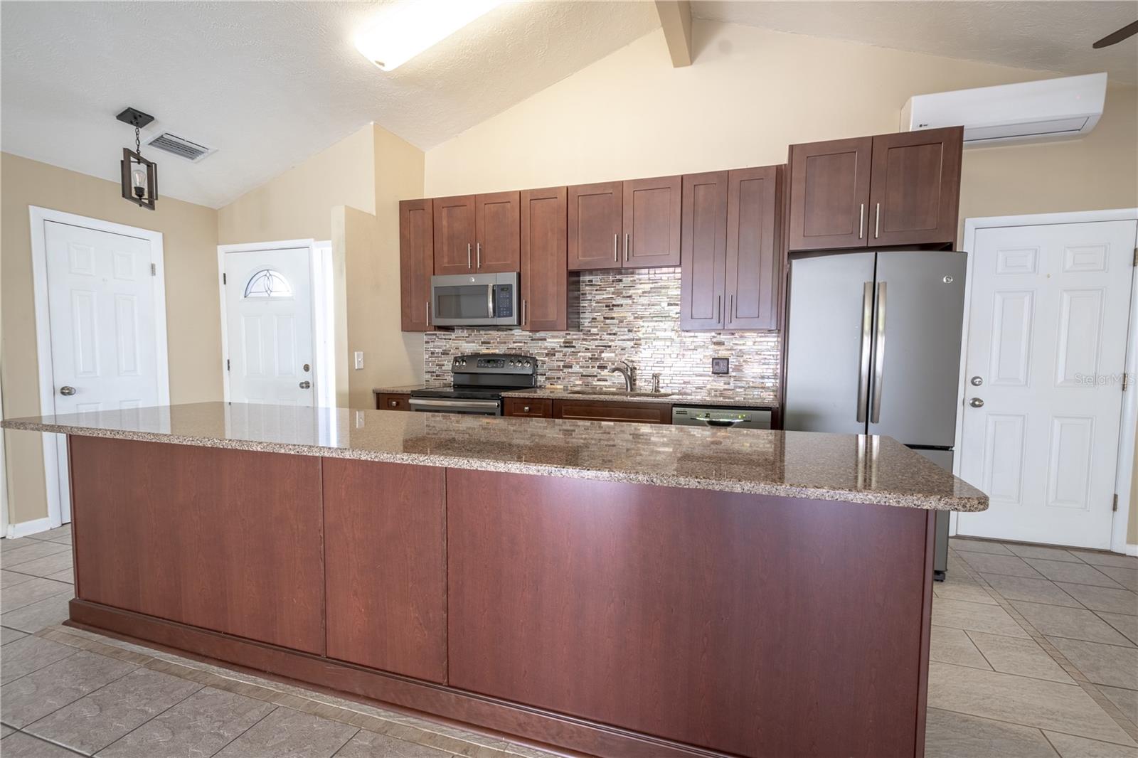 The wood cabinets are complimented by a stylish tile backsplash.