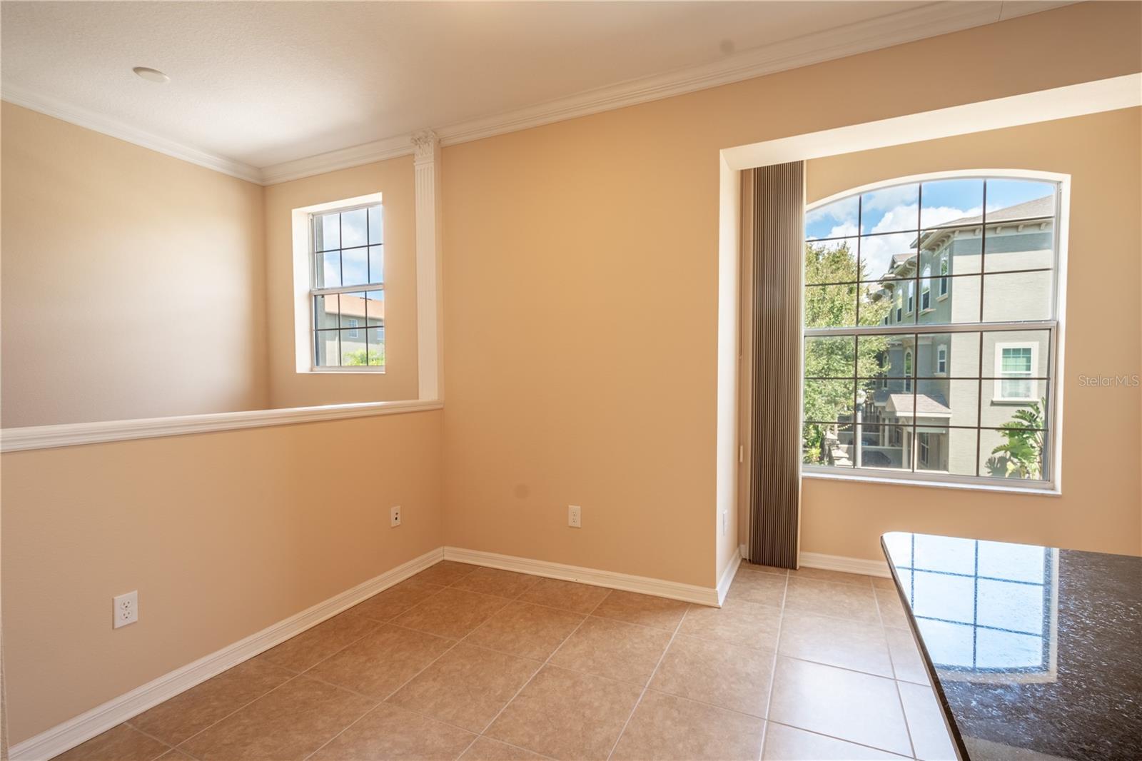 The space is beautifully finished with elegant crown molding and sleek ceramic tile flooring, adding a touch of sophistication and easy maintenance to your everyday living.