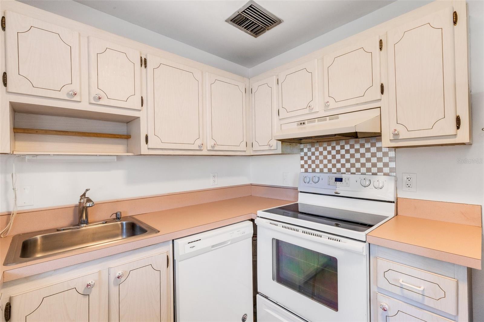 Kitchen with dishwasher, range.