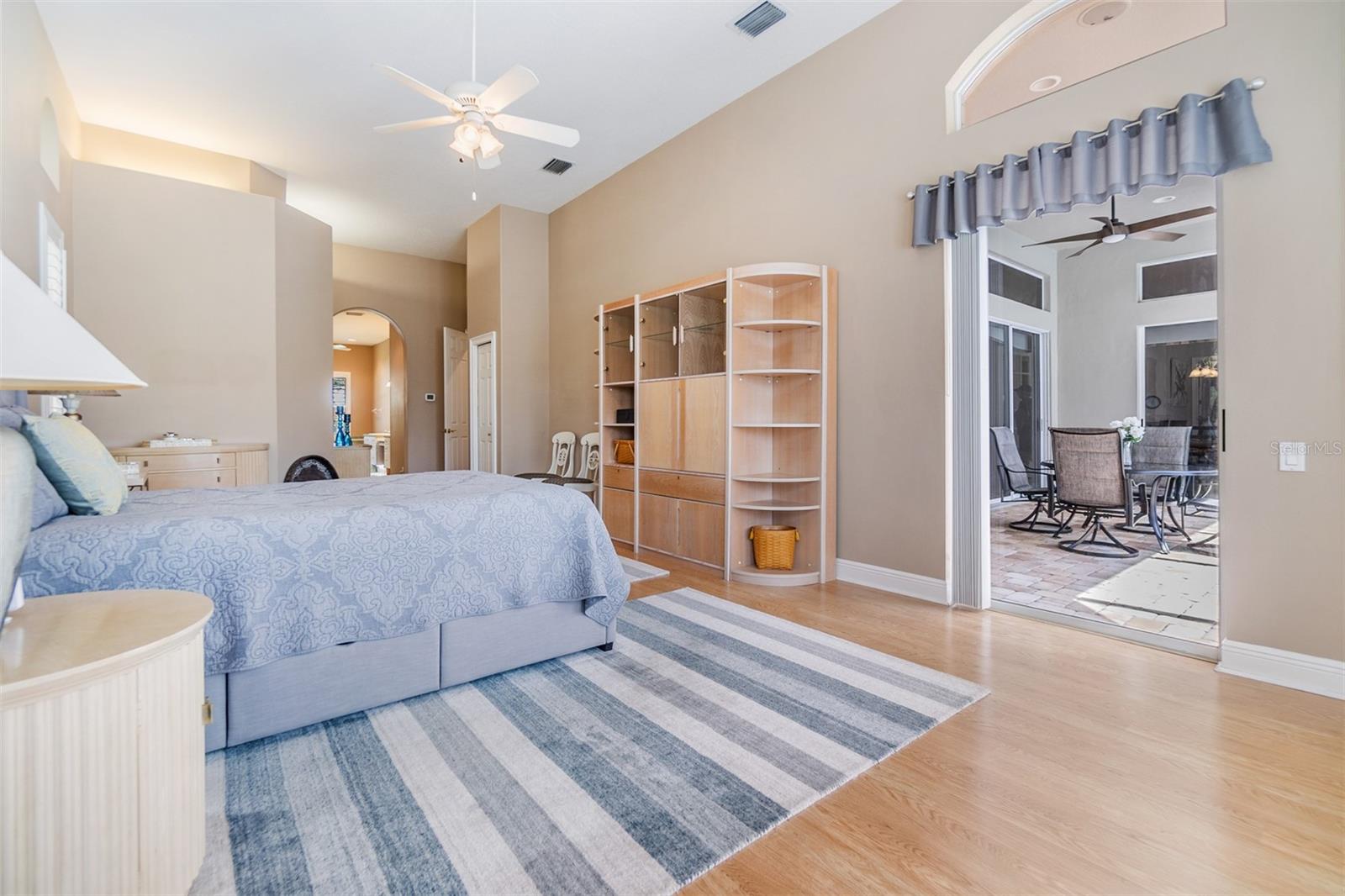 Master Bedroom with view of the pool and pond, Vaulted ceilings and ceiling fan.