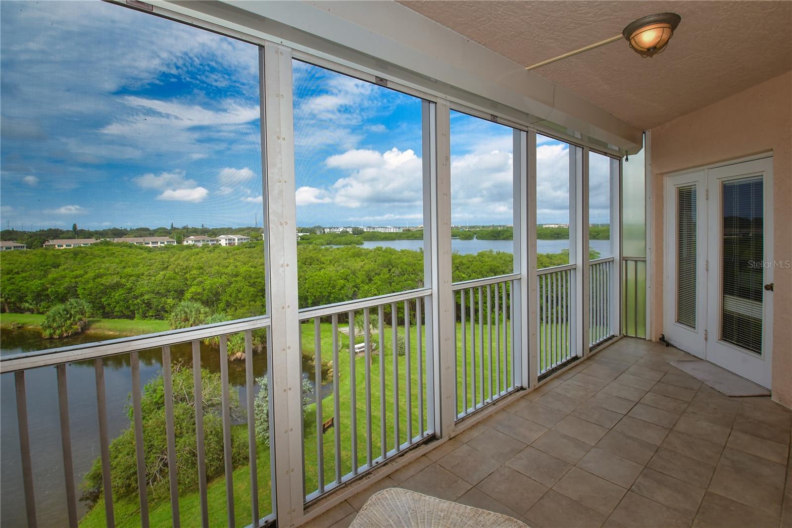 ... and Long Bayou on the other side. Note the private door between the Primary Bedroom and the Lanai AND the hurricane shutters completely across the lanai screens.