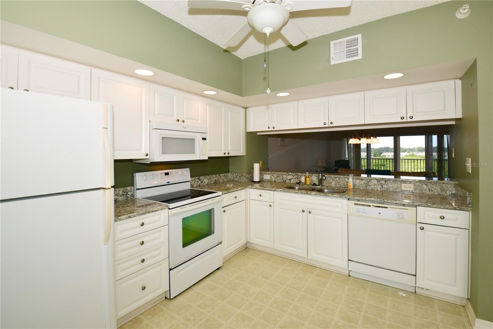 The kitchen enjoys lots of cabinet space along with a beautiful quartz countertop.