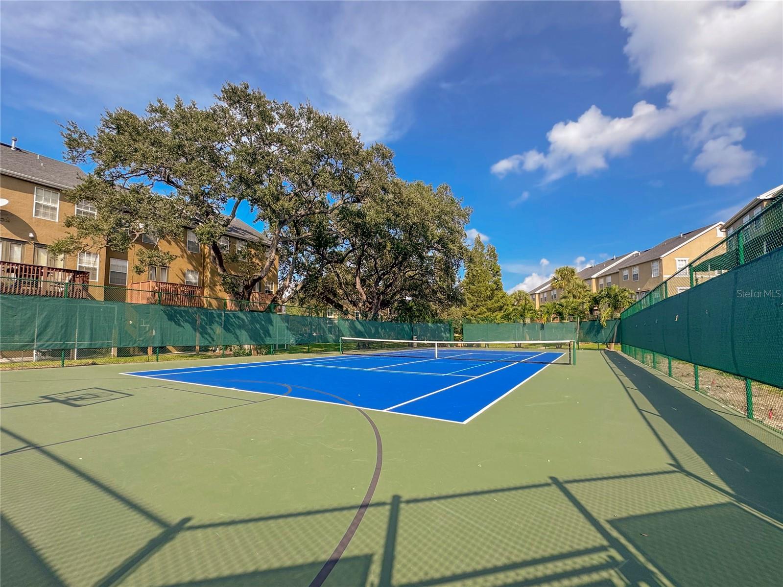 Tennis court with half court for basketball.