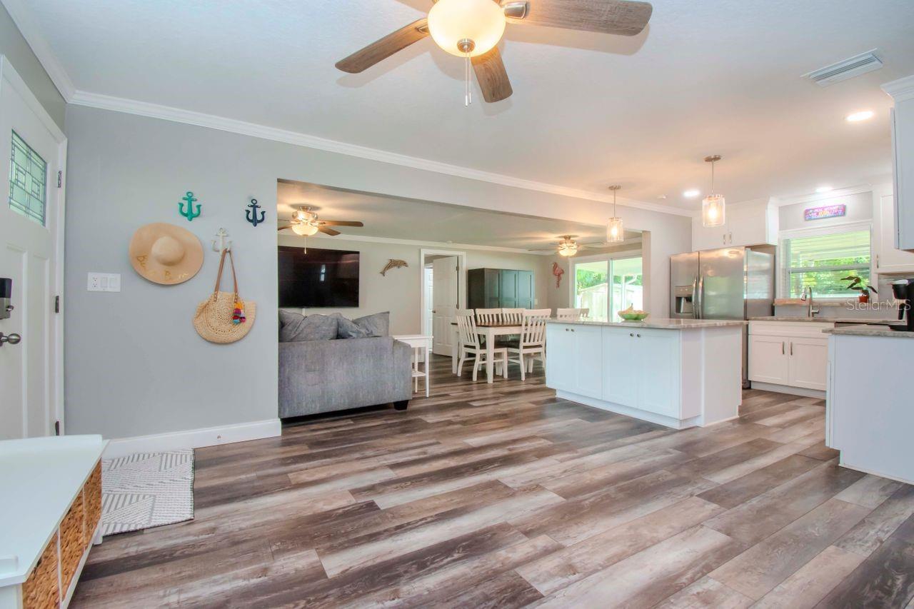 Great room view to dining area and kitchen with island