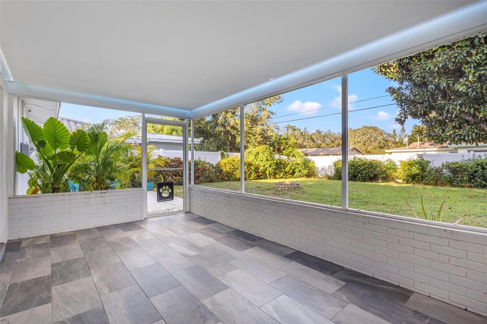 Large tiled and screened-in patio