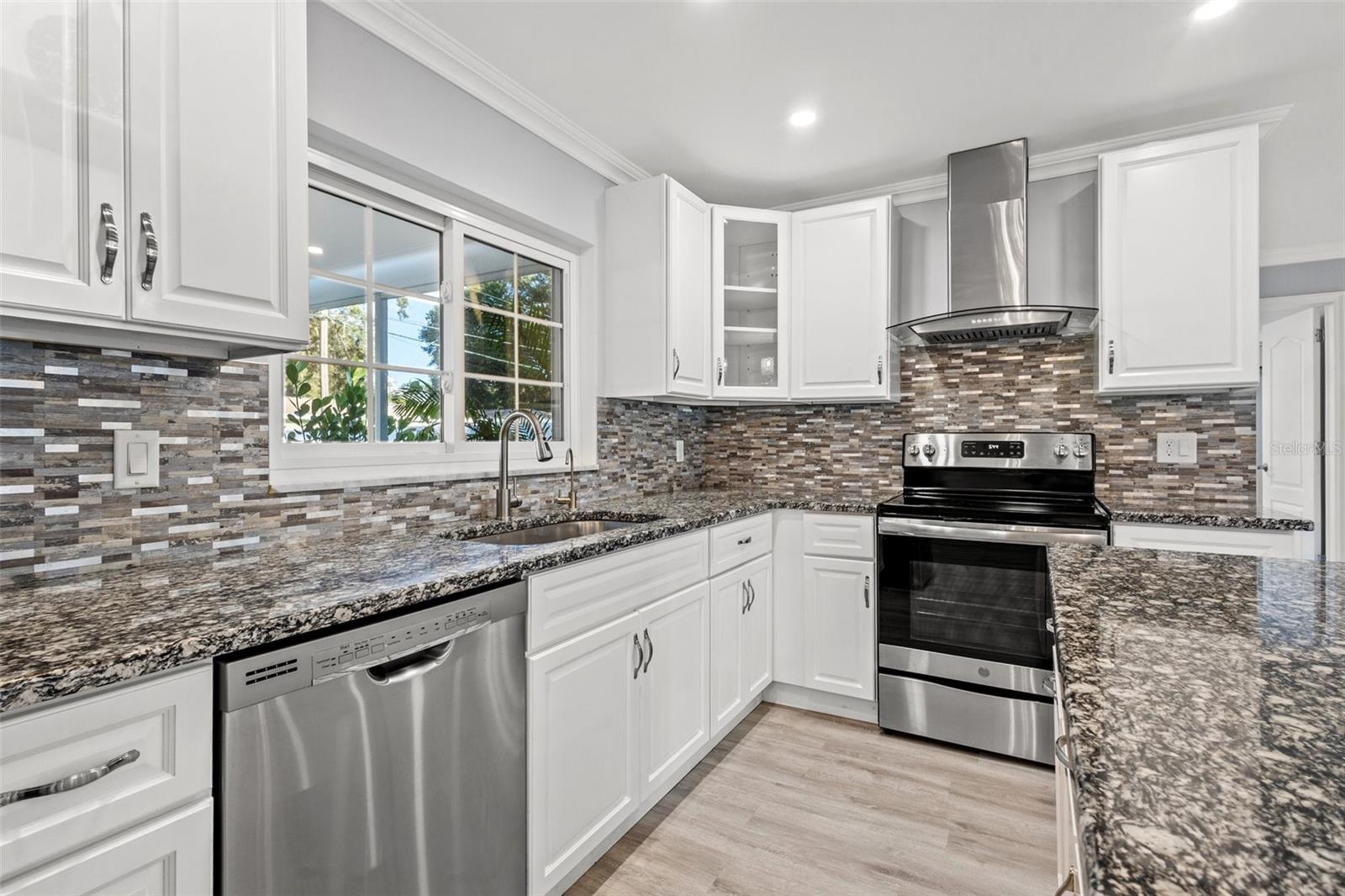 High end stainless appliances and white cabinets