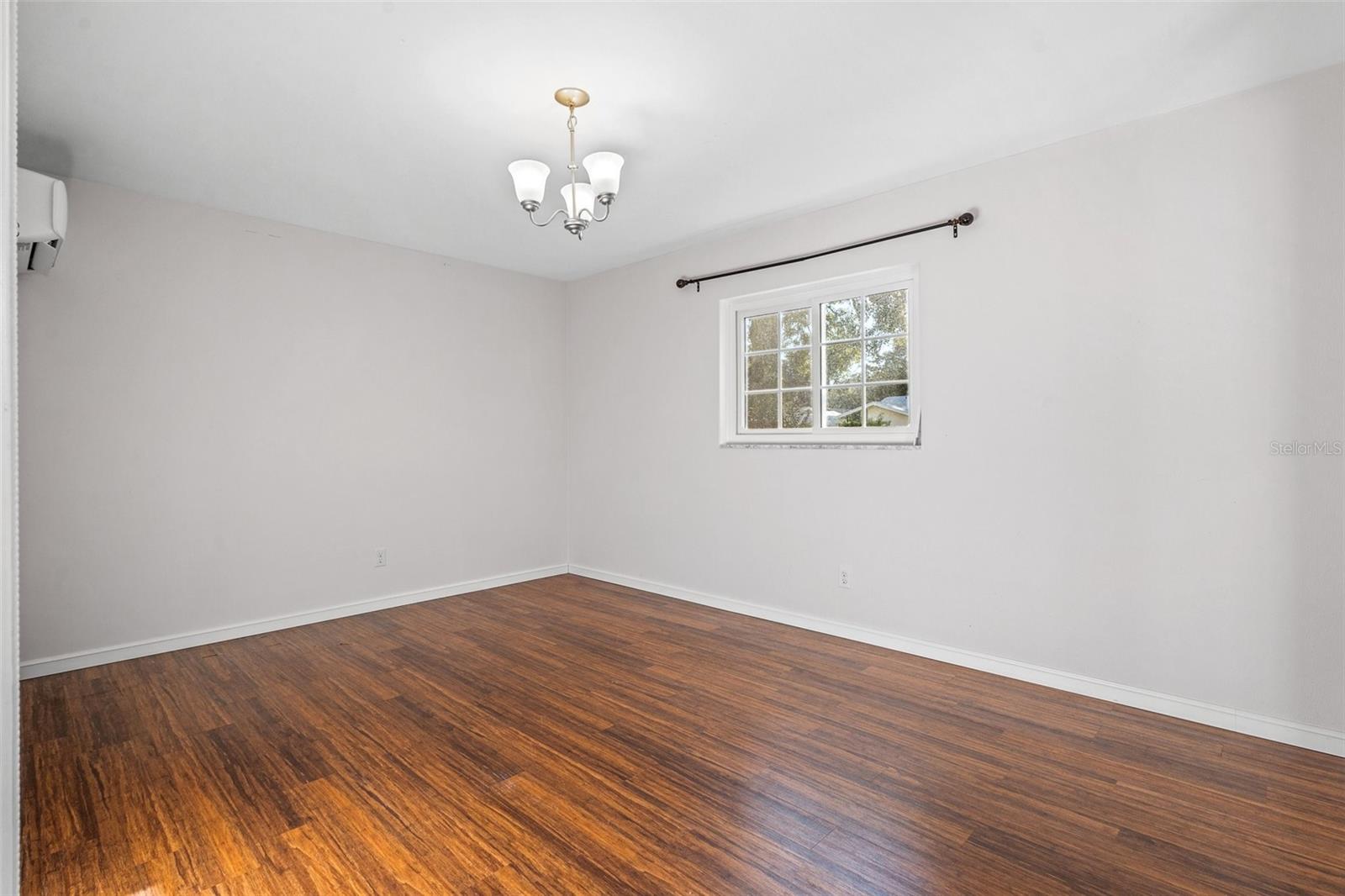 Large master bedroom with beautiful wood floors and separate temperature control