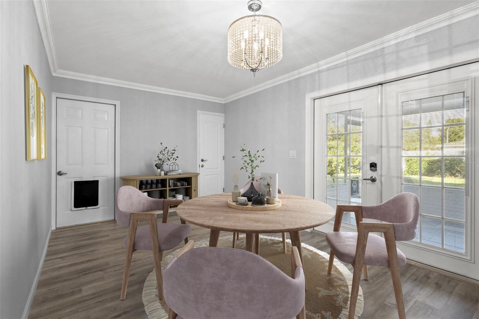 Virtually staged dining area with natural light pouring in from french doors