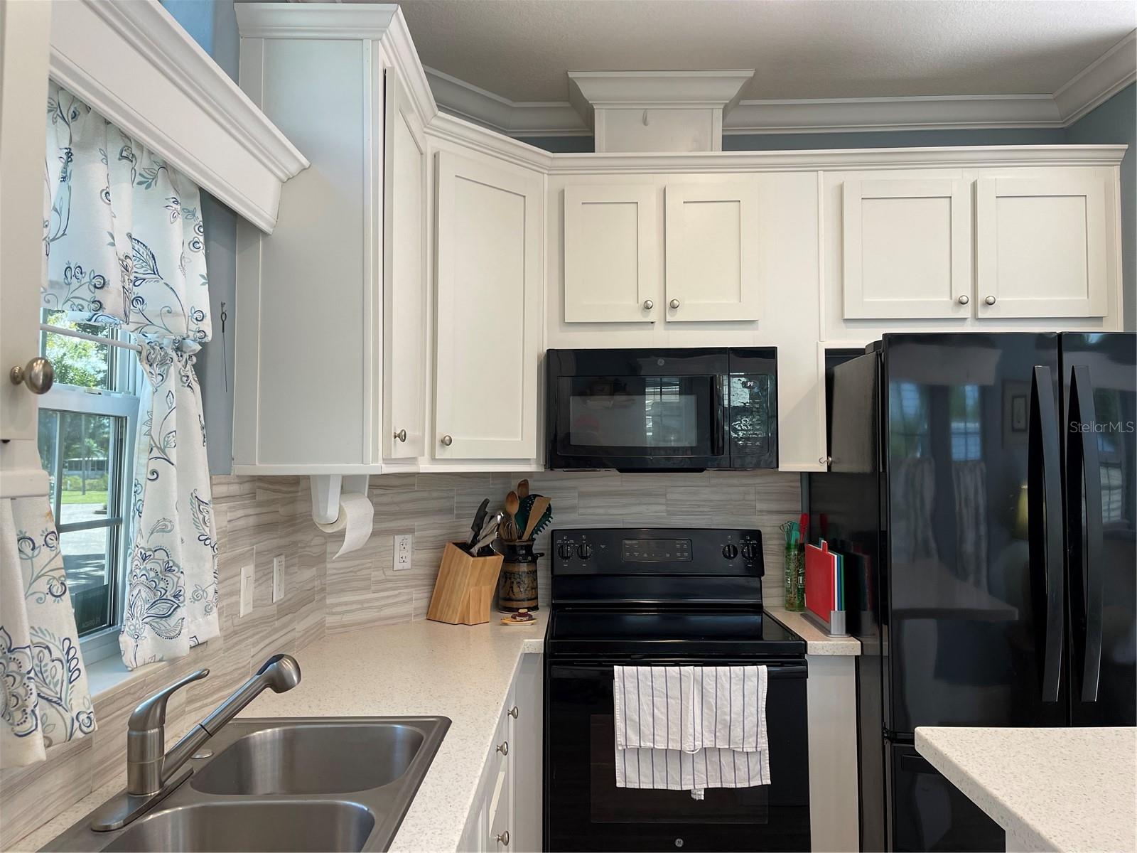 Tiled backsplash on kitchen walls.