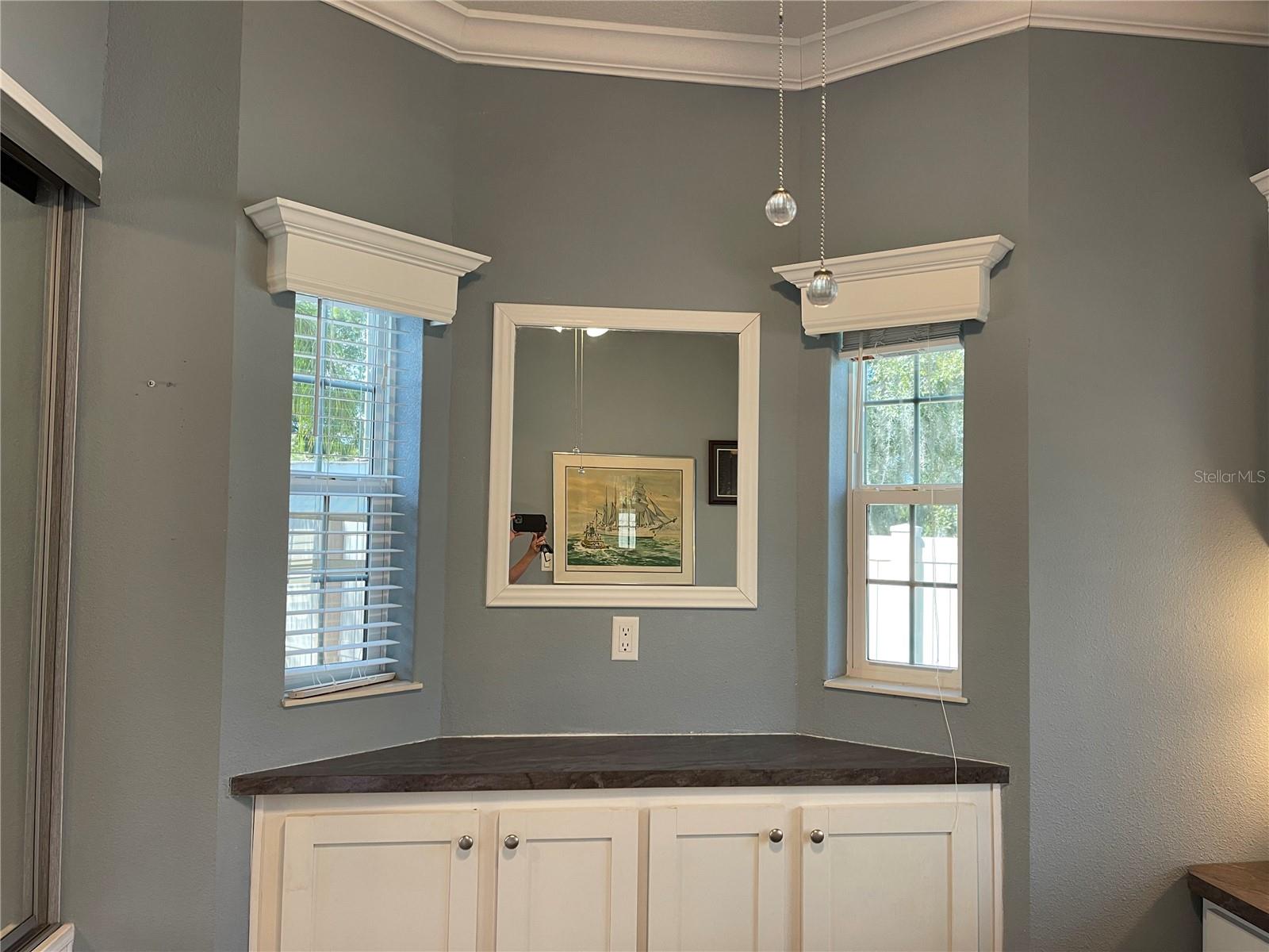 Built in cabinets, valances above windows in bedroom