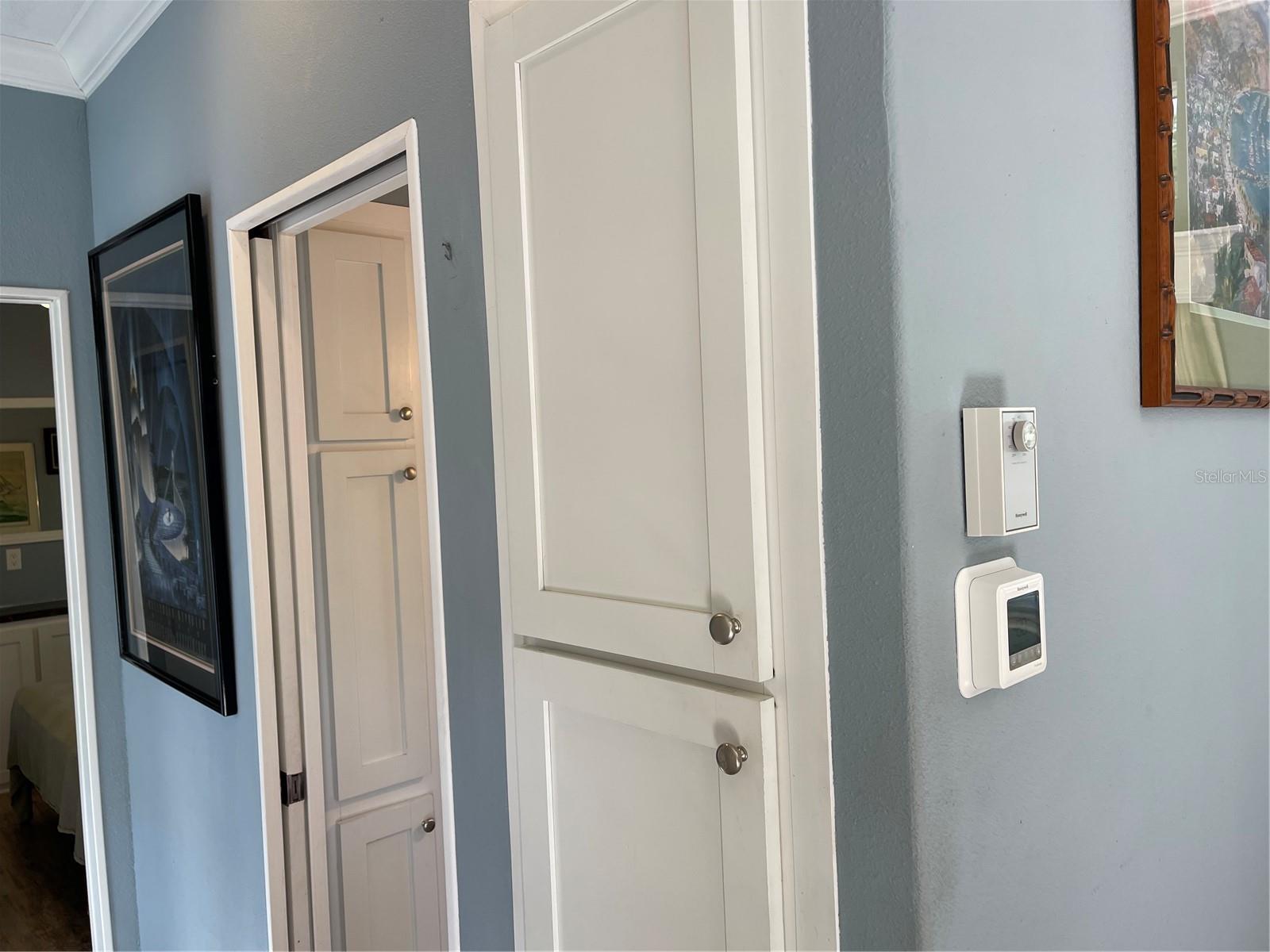 Pocket door leads to bathroom with linen closet