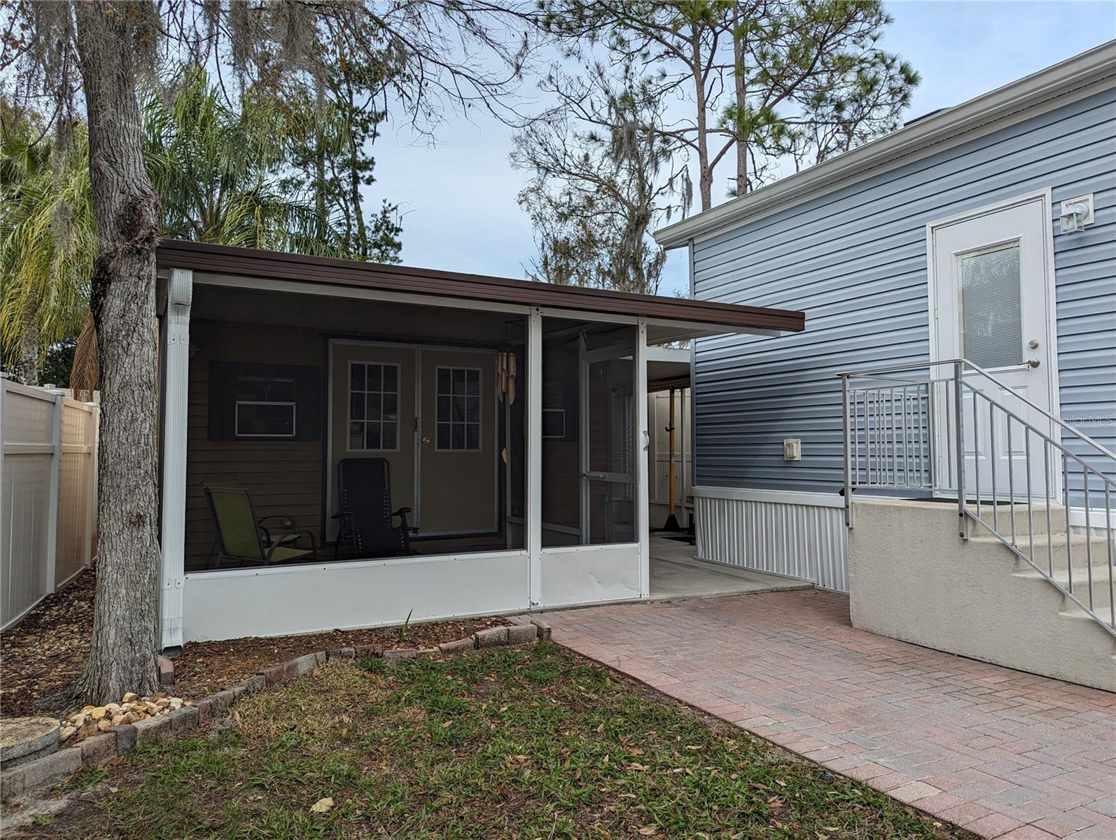 Behind this screened porch and worshop is a small private courtyard with outdoor shower.