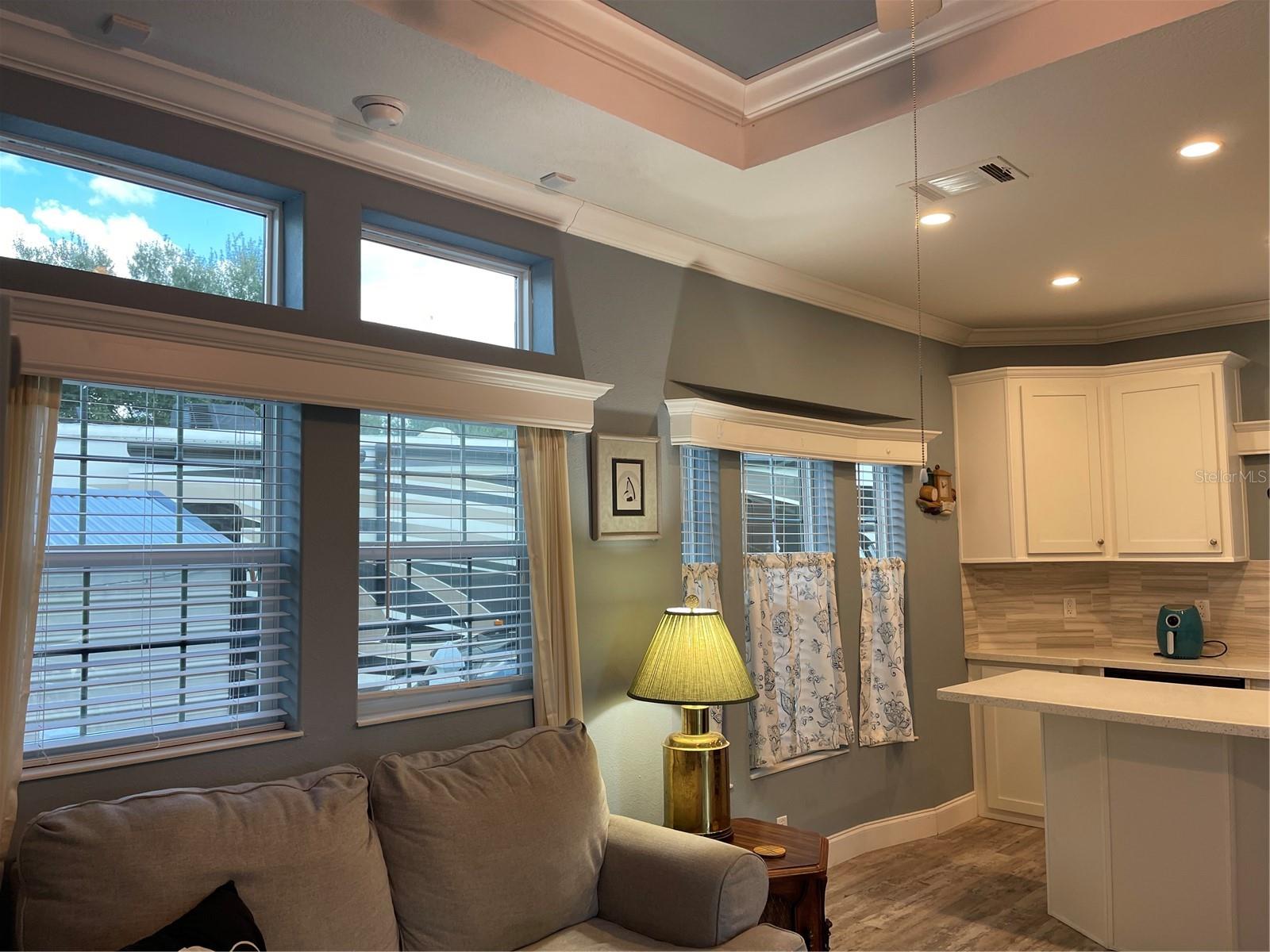 Transom windows above windows invites extra sunshine into the home.