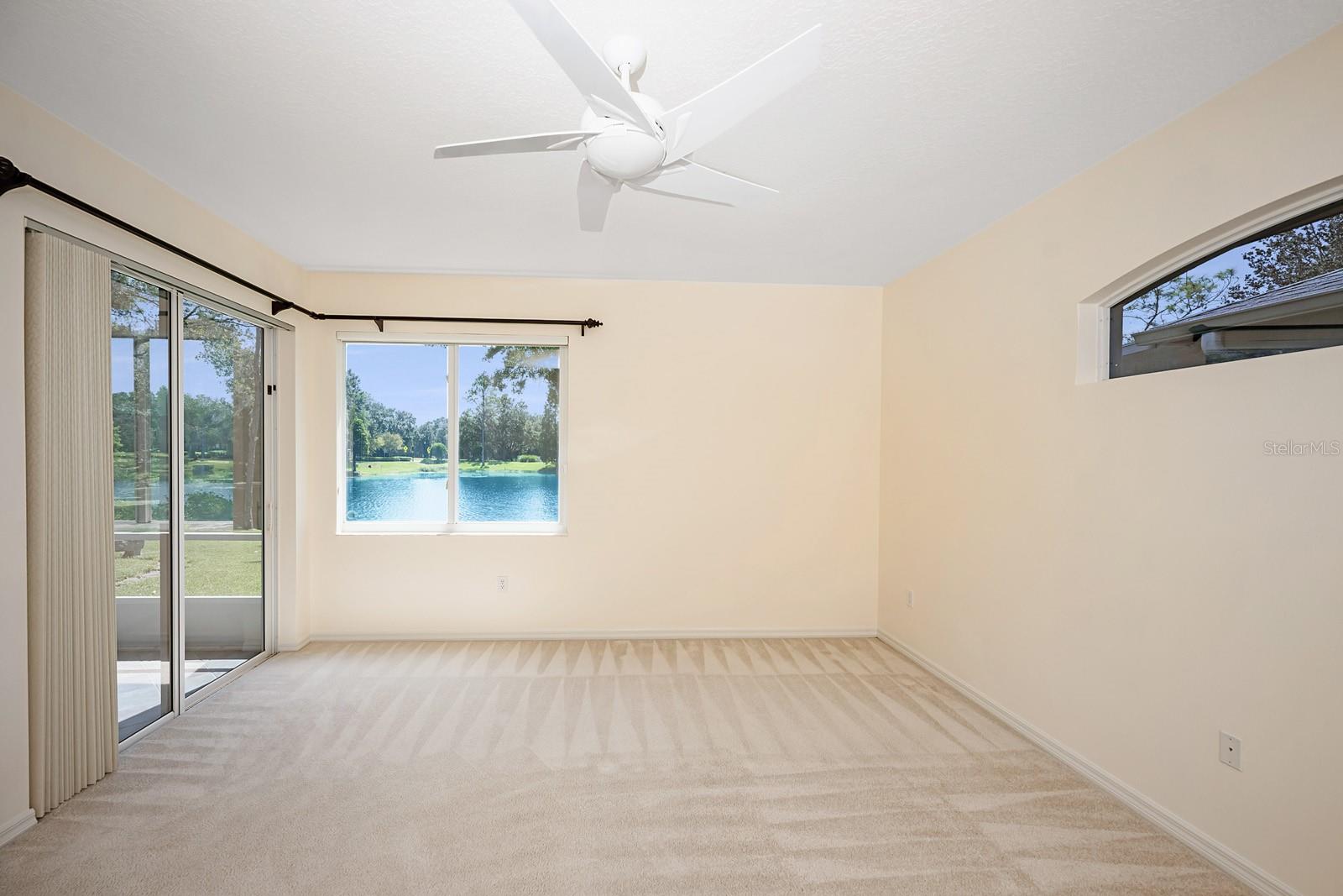 Main bedroom with pond view, all tinted windows