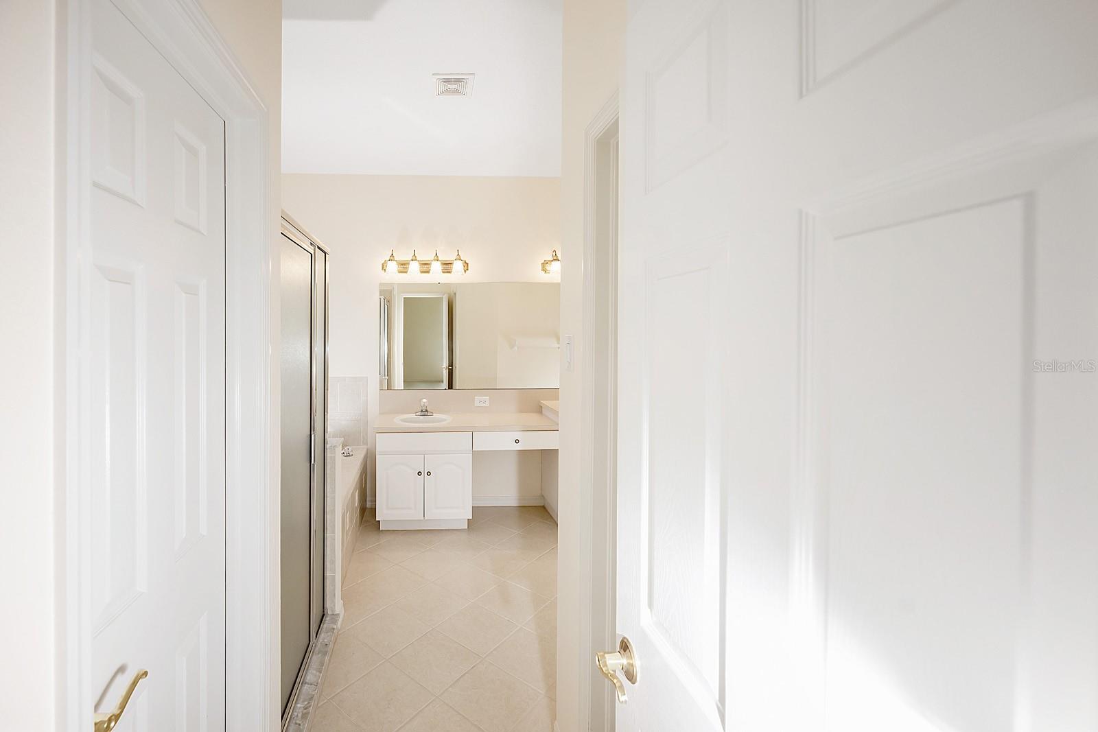 Main bathroom with walk-in closets, walk-in shower and garden tub.