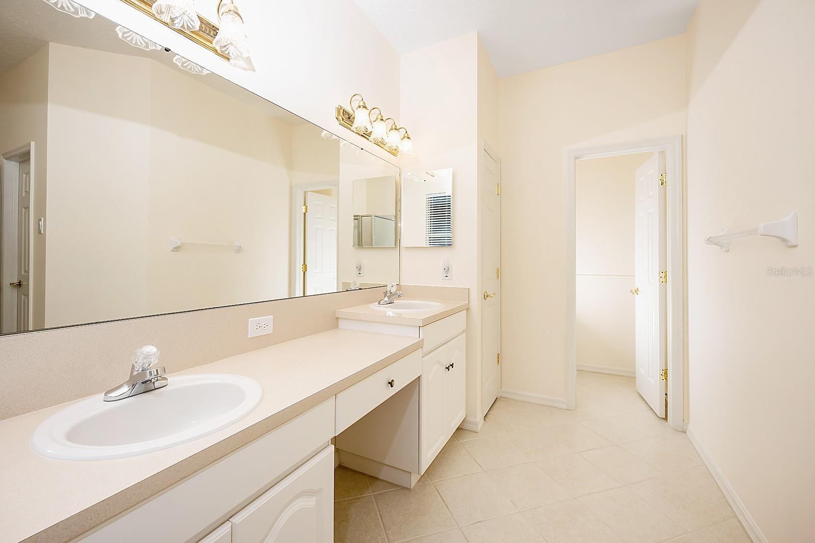 Main bathroom with view into water closet.