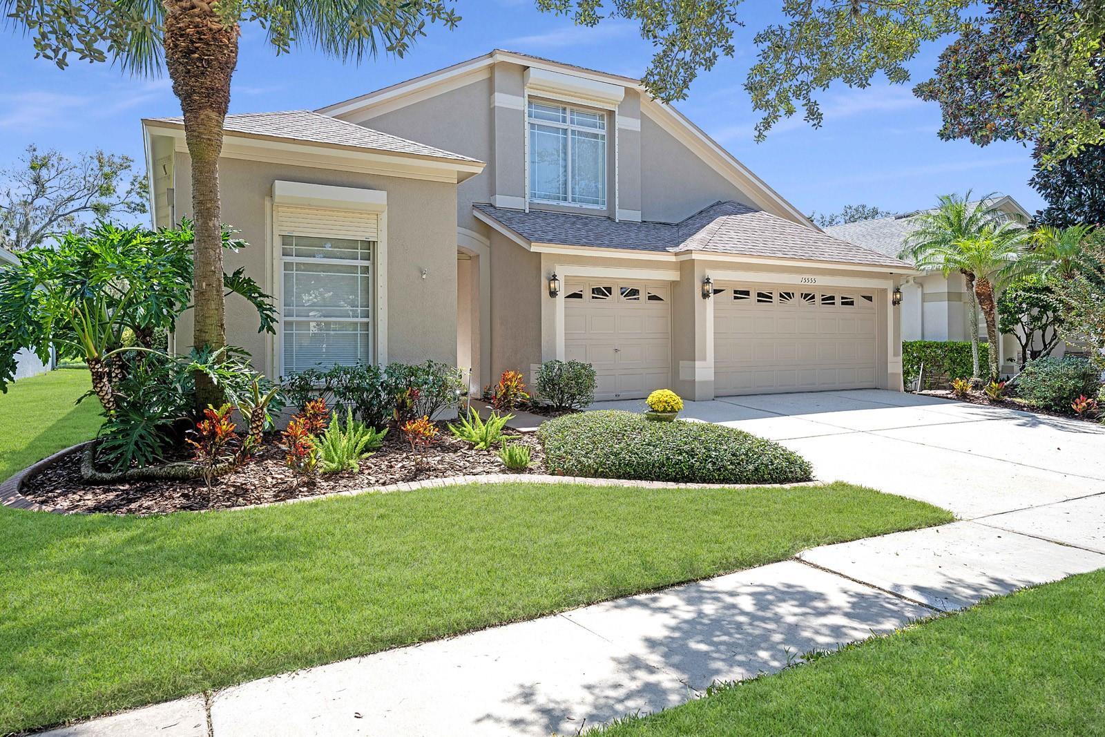 Welcome to 15555 Martin Meadow Drive with well-manicured lawn and landscaping