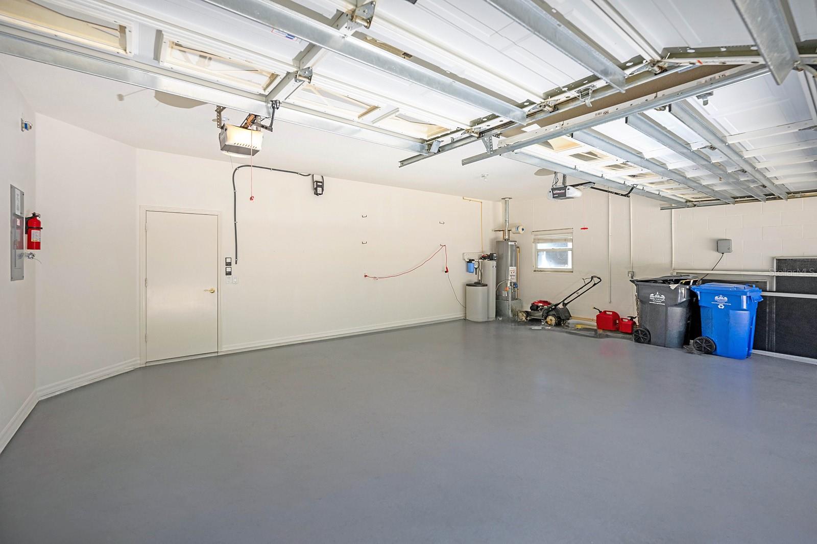 Look at this huge 3-car garage with new paint on walls and floor