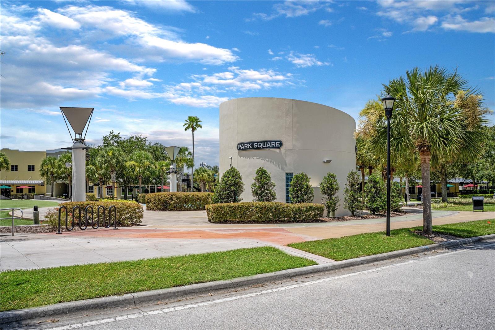 Park Square containing green space, splash pad, retail stores, restaurants