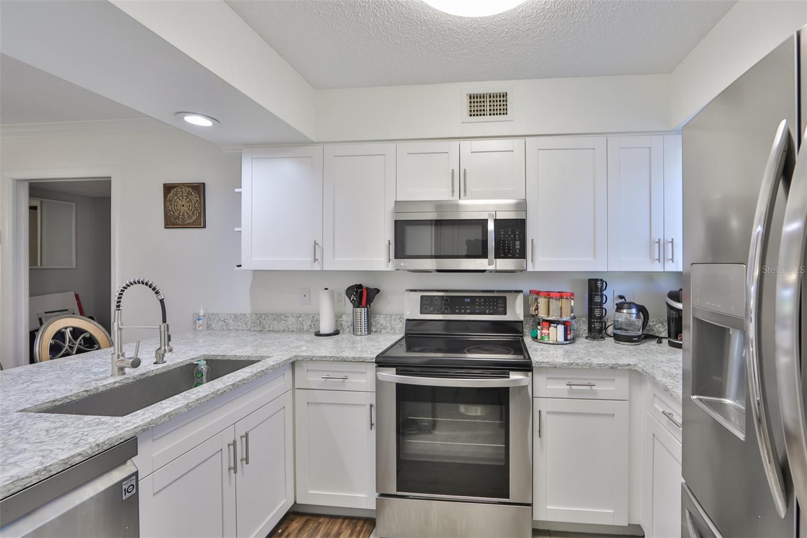 Updated Kitchen with Stainless Steel applianes, granite countertops, update cabinetry, and a window in the kitchen