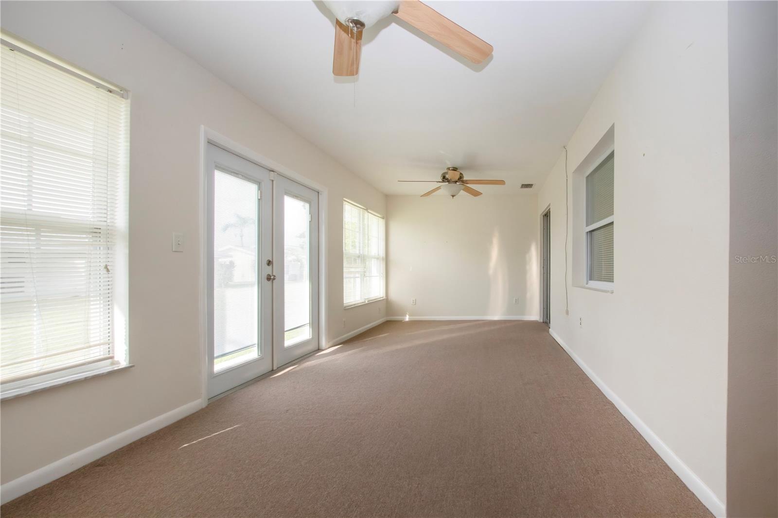 Large family room with user friendly indoor/outdoor carpet, new exterior doors.