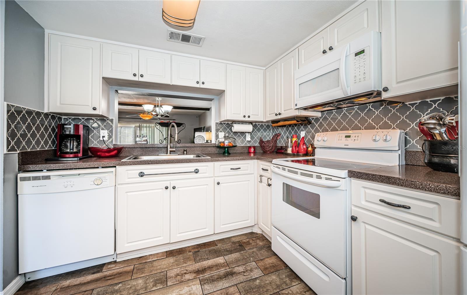 White cabinets in kitchen with pass-thru