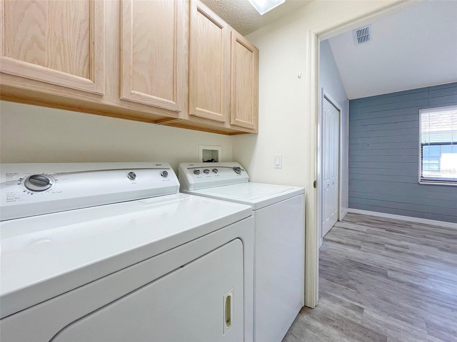 INSIDE LAUNDRY ROOM WITH CABINET STORAGE