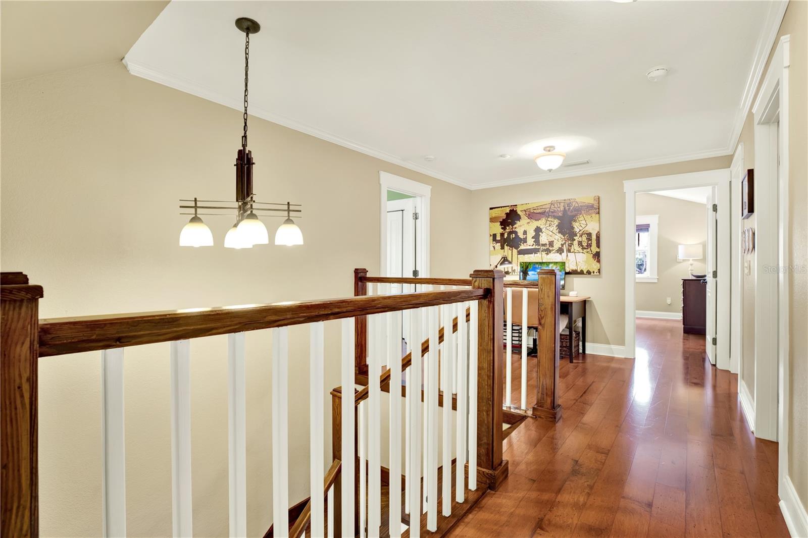 The upper level's open hallway makes getting to the 3 bedrooms and additional two baths a bright and not tight experience