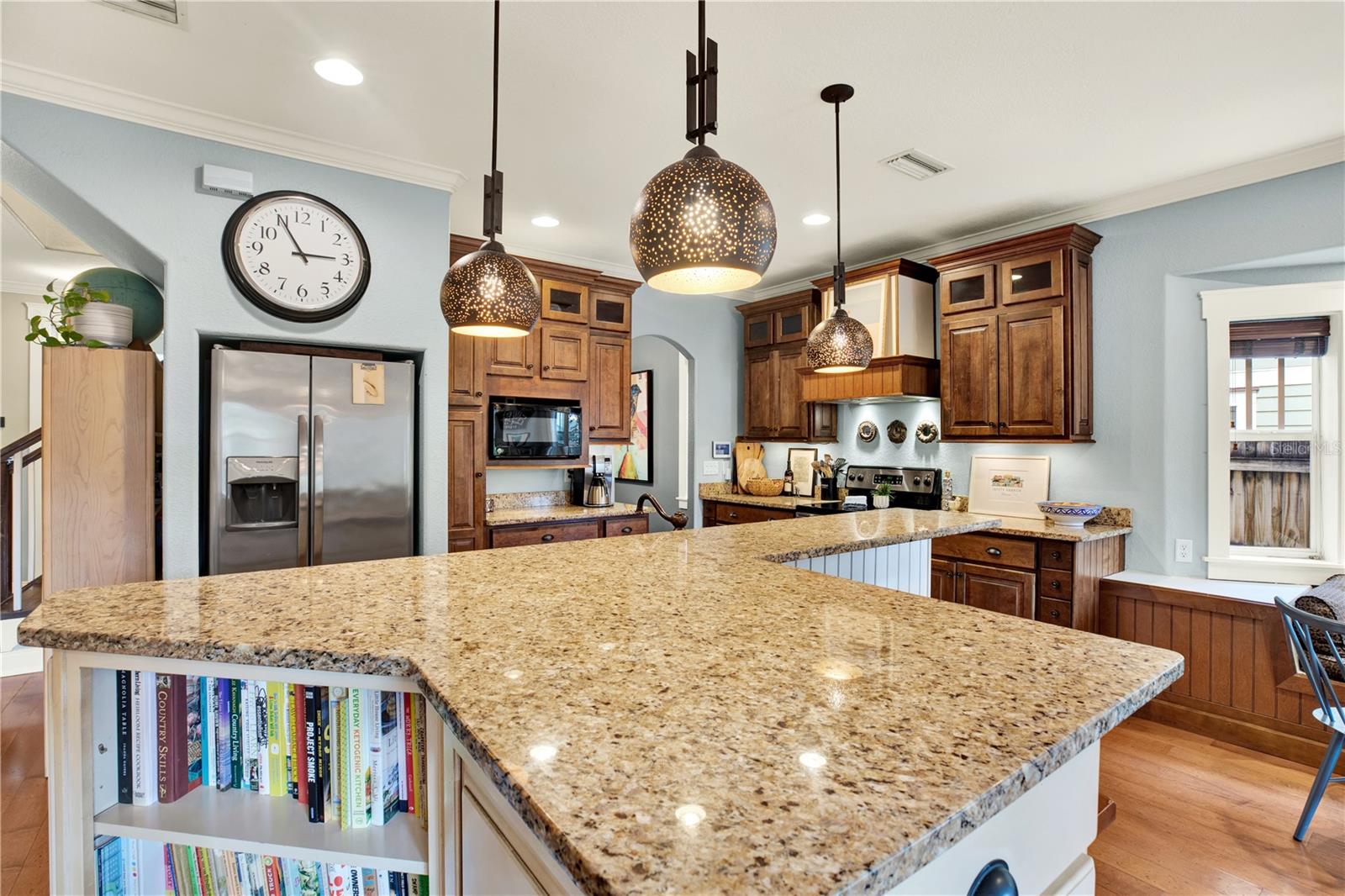 The kitchen offers plenty of counter space along with bookshelves to house your most loved cookbooks