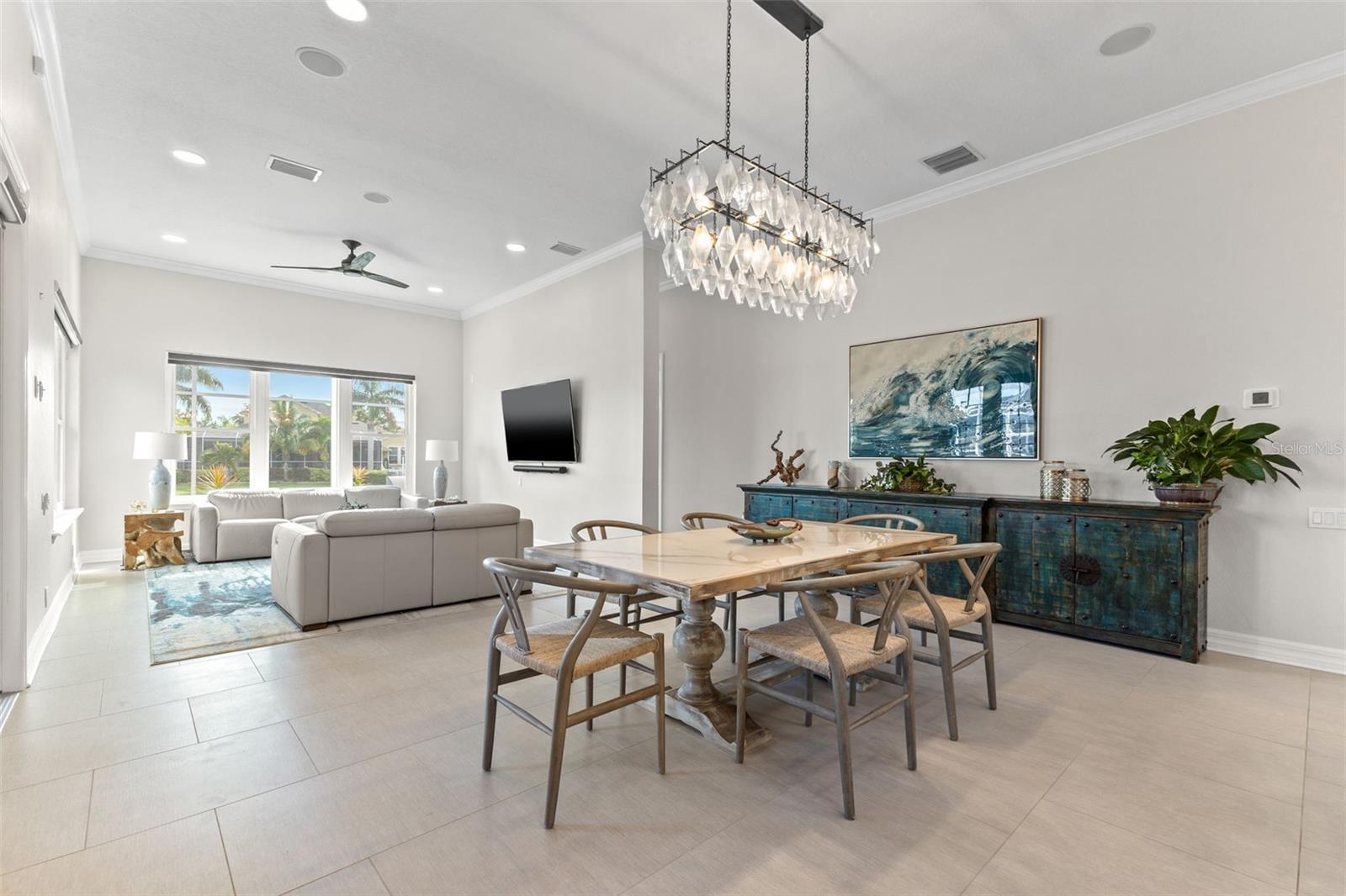 Dining room with view into the family room, pool and waterfront