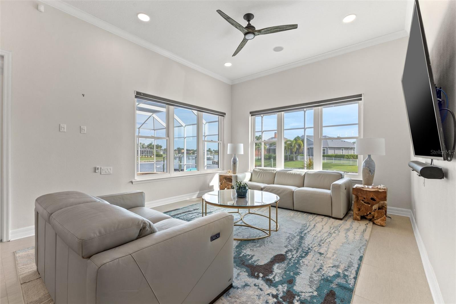 Family room with view to beautiful pool, dock and waterfront