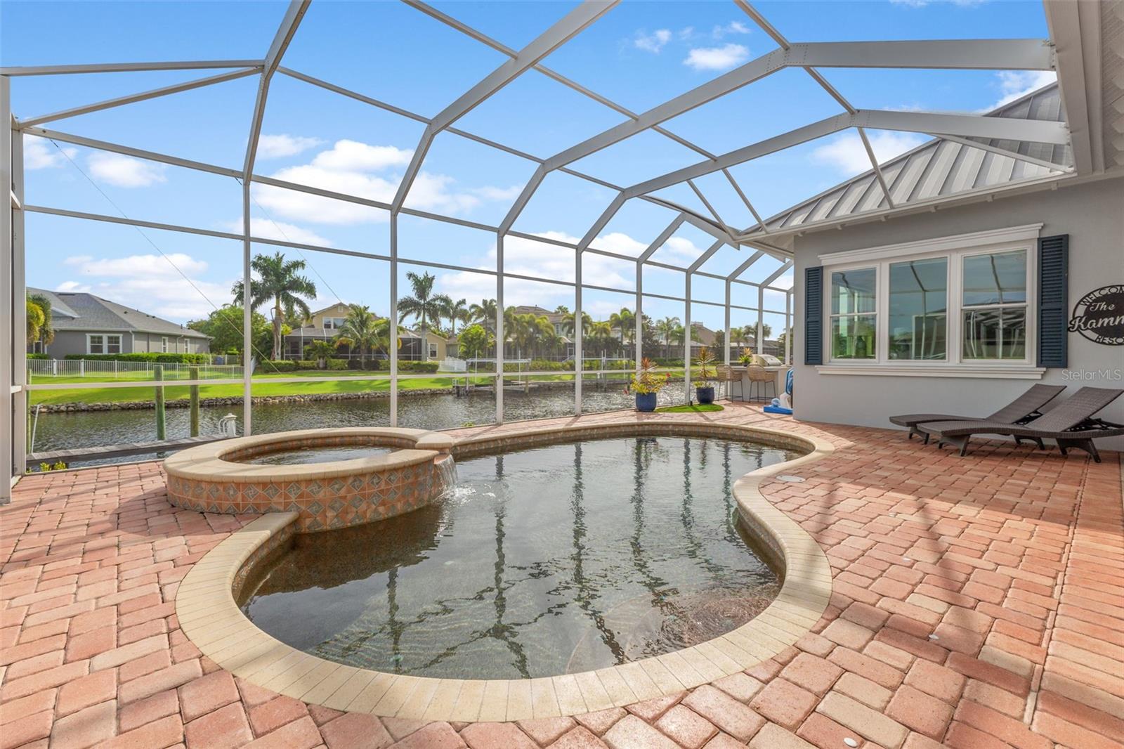 Beautiful heated pebble tech pool, spa with gorgeous pavers and view to waterfront