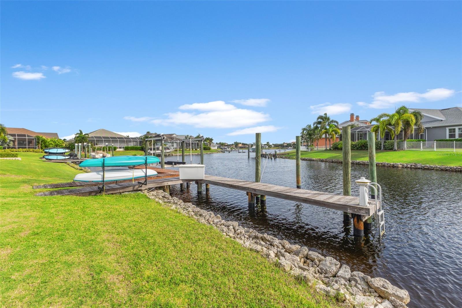 Back yard with view of dock which has electricity and water, just needs a boat lift