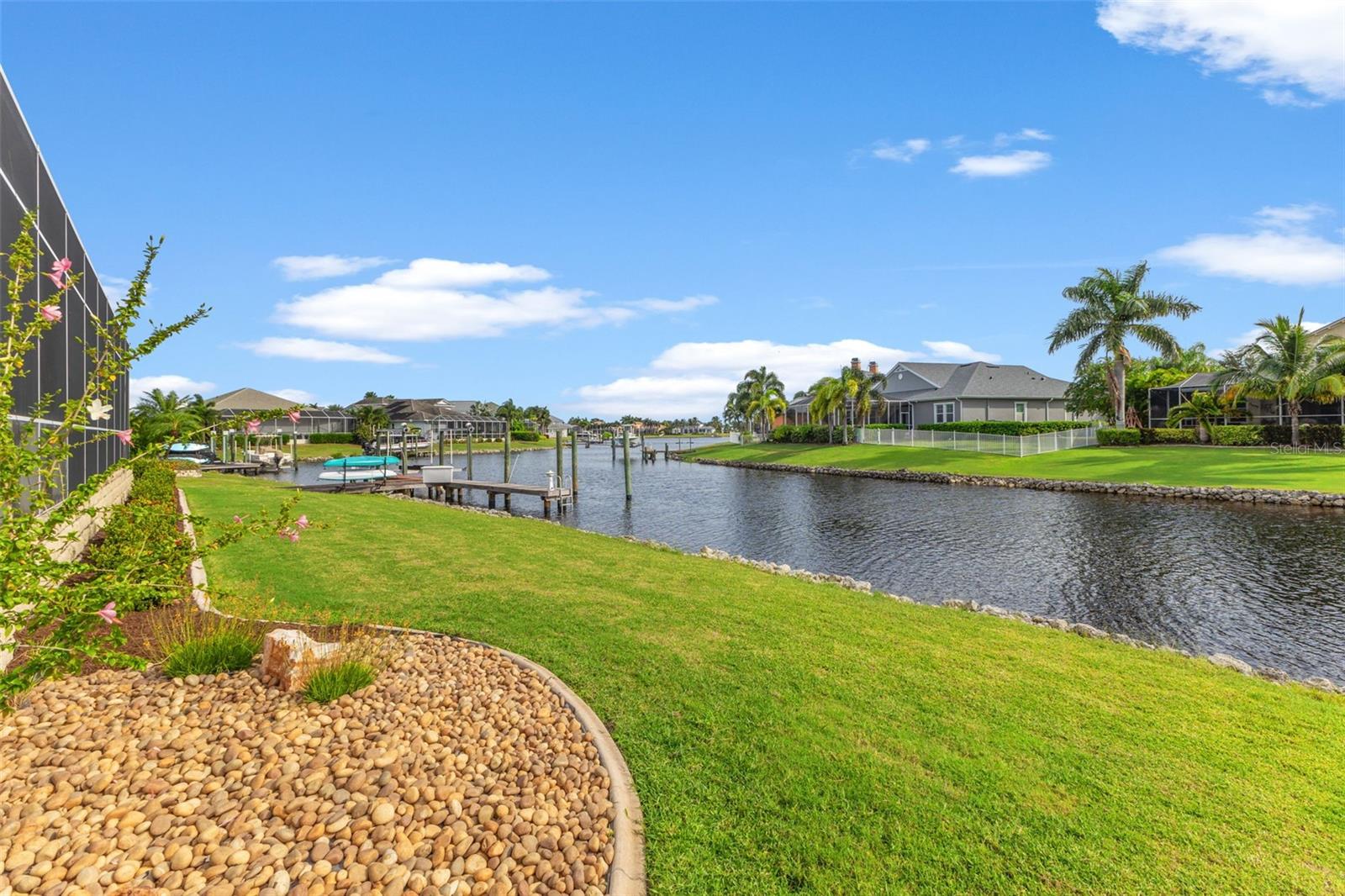 Back yard with view of dock which has electricity and water, just needs a boat lift