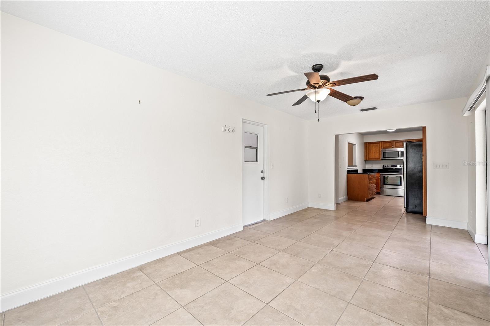 view from 2nd living space into the kitchen, door leads to the garage