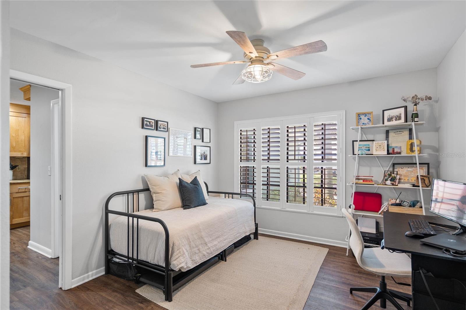 Guest bedroom downstairs with french doors & interior shutters