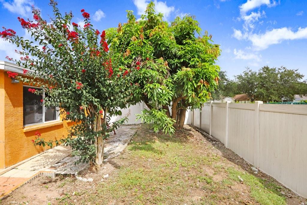 Rear of home with covered Florida room with A/C and windows