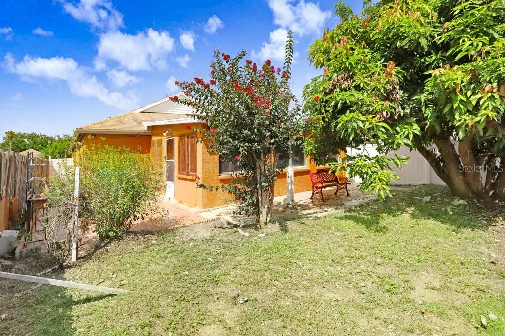 Rear of home with covered Florida room with A/C and windows