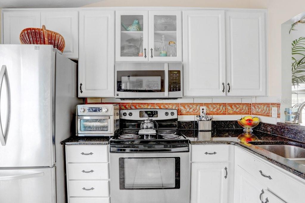 Kitchen with granite countertops/ 42" cabinets and stainless steel appliances