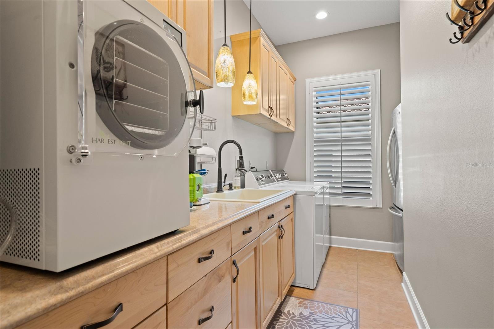 Inside laundry with refrigerator that conveys.