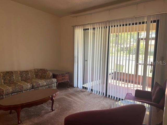 Living room with access to screened in porch.