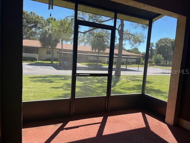 Screened in patio in the back with a storage room