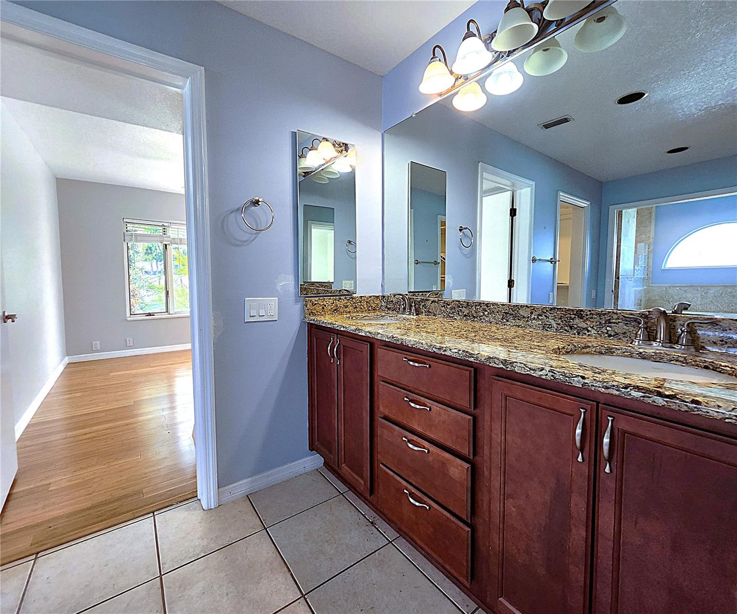 Jack-n-Jill Master Bathroom includes His & Hers Walk-in closets, private water closet, tiled walk-in shower, garden tub with jets, dual sink vanity