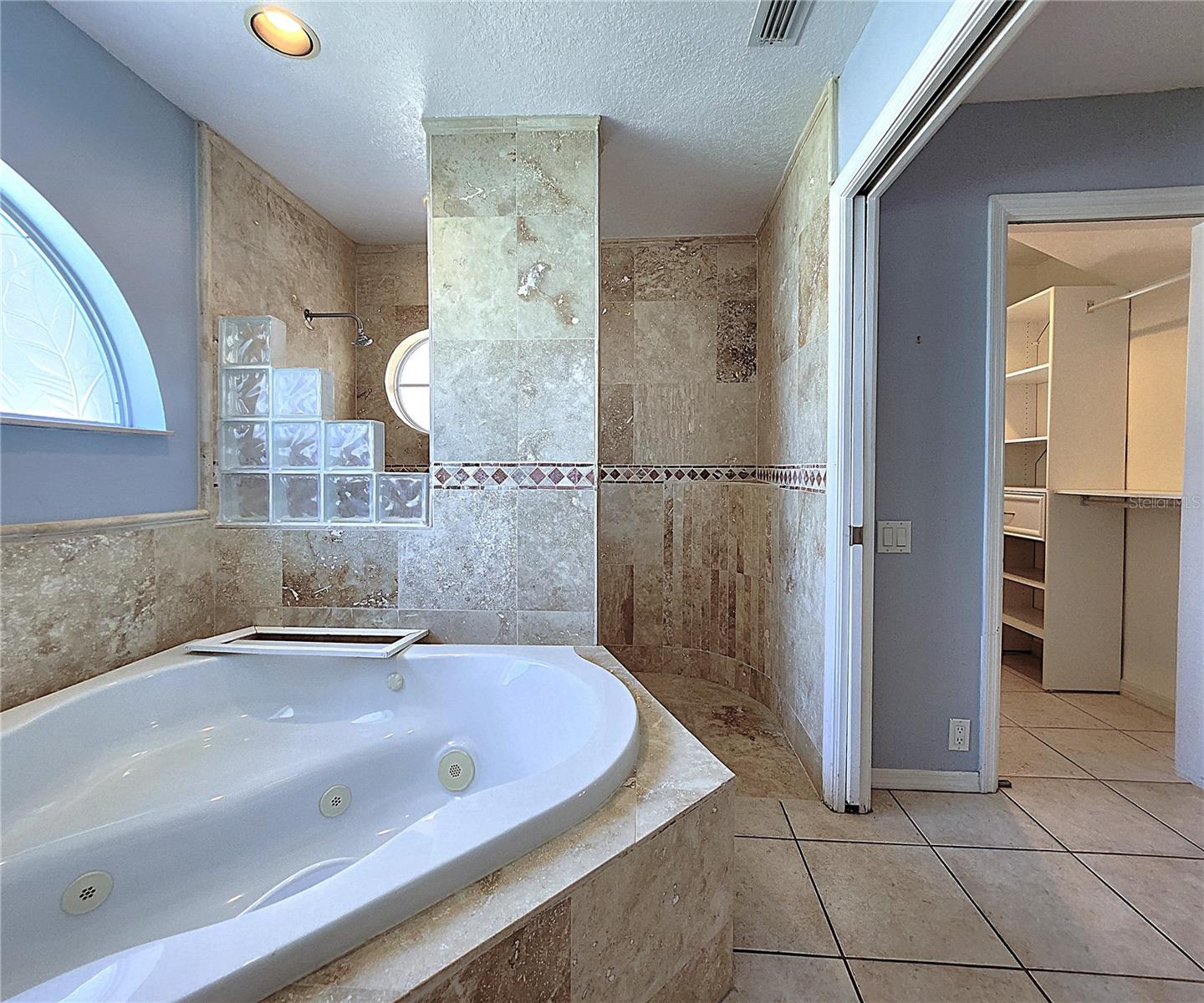 Jack-n-Jill Master Bathroom includes His & Hers Walk-in closets, private water closet, tiled walk-in shower, garden tub with jets, dual sink vanity