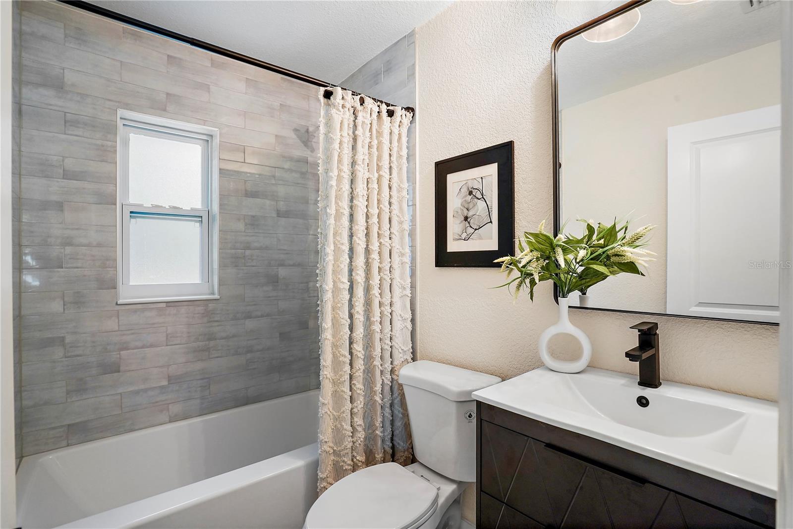 Hallway Bathroom with custom tile and tub/ shower combo