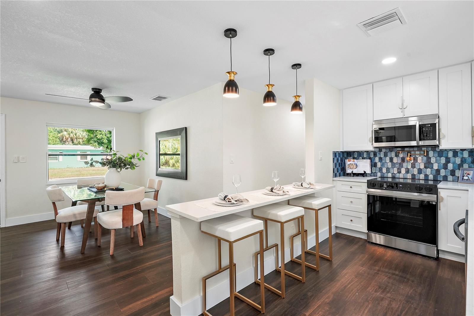 Kitchen has custom backsplash, pot filler over range and ample storage