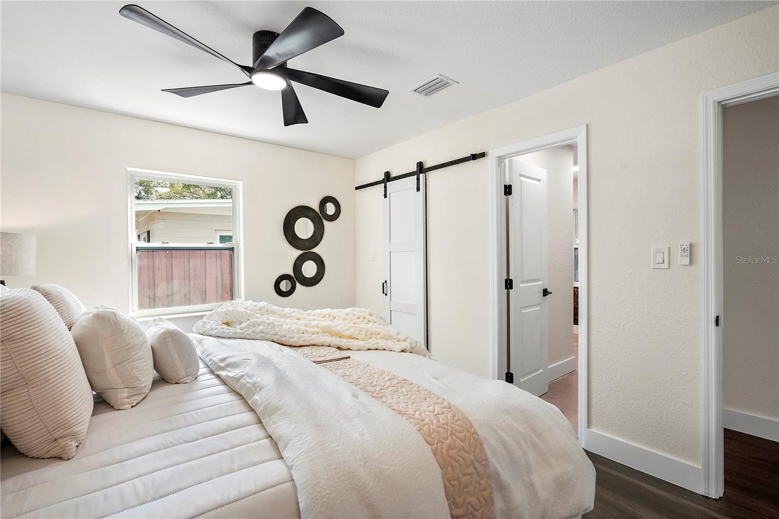 Primary Bedroom with view of walk in closet and door to en suite bathroom