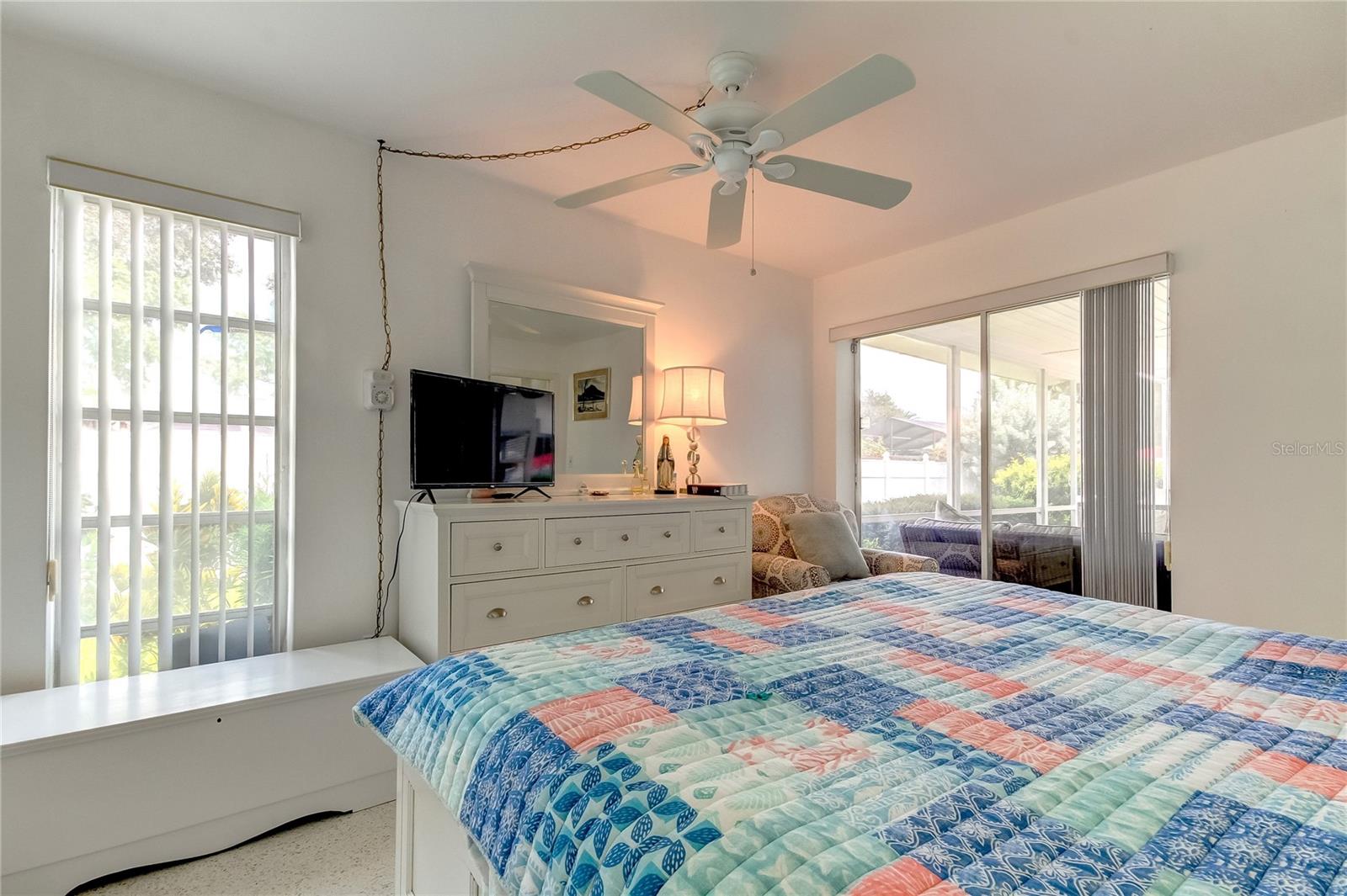 Bedroom 3 with sliders out onto covered, screened patio