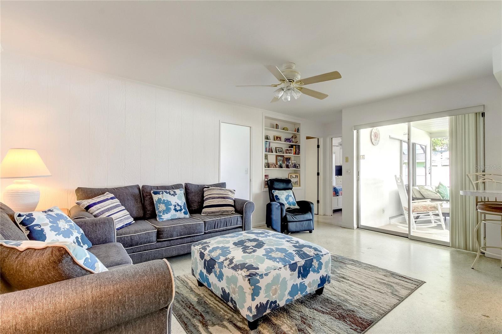 Family room with sliders to covered, screened patio